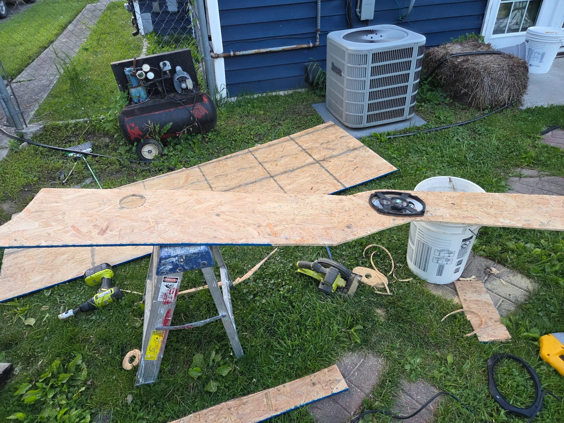 Panel templates and raw sheet material during fabrication.