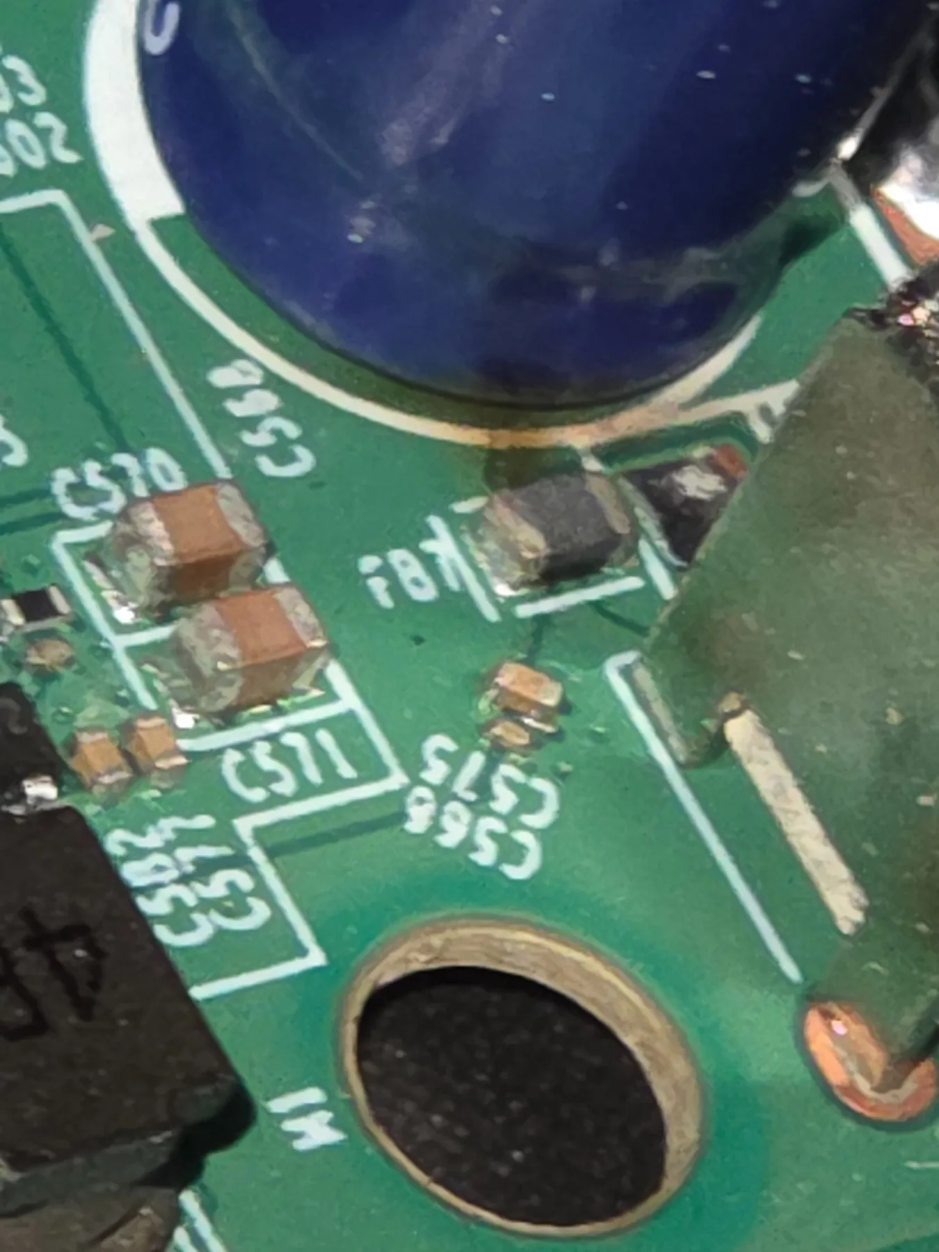 Close inspection of a suspect surface-mount area on the vending controller PCB.