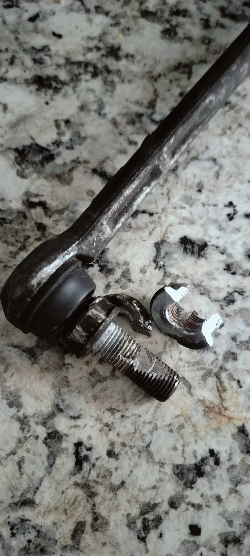 Failed steering or suspension link hardware removed during diagnosis.